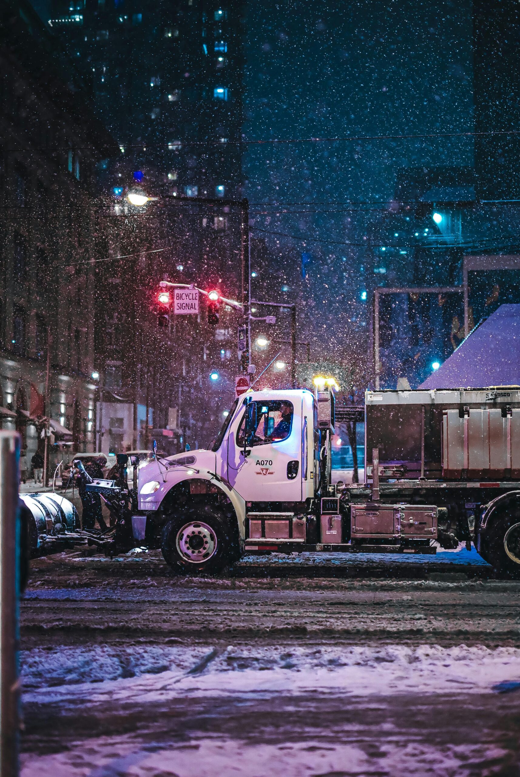 An image of Big Al's snow removal equipment working on a snow removal project within a commercial area.