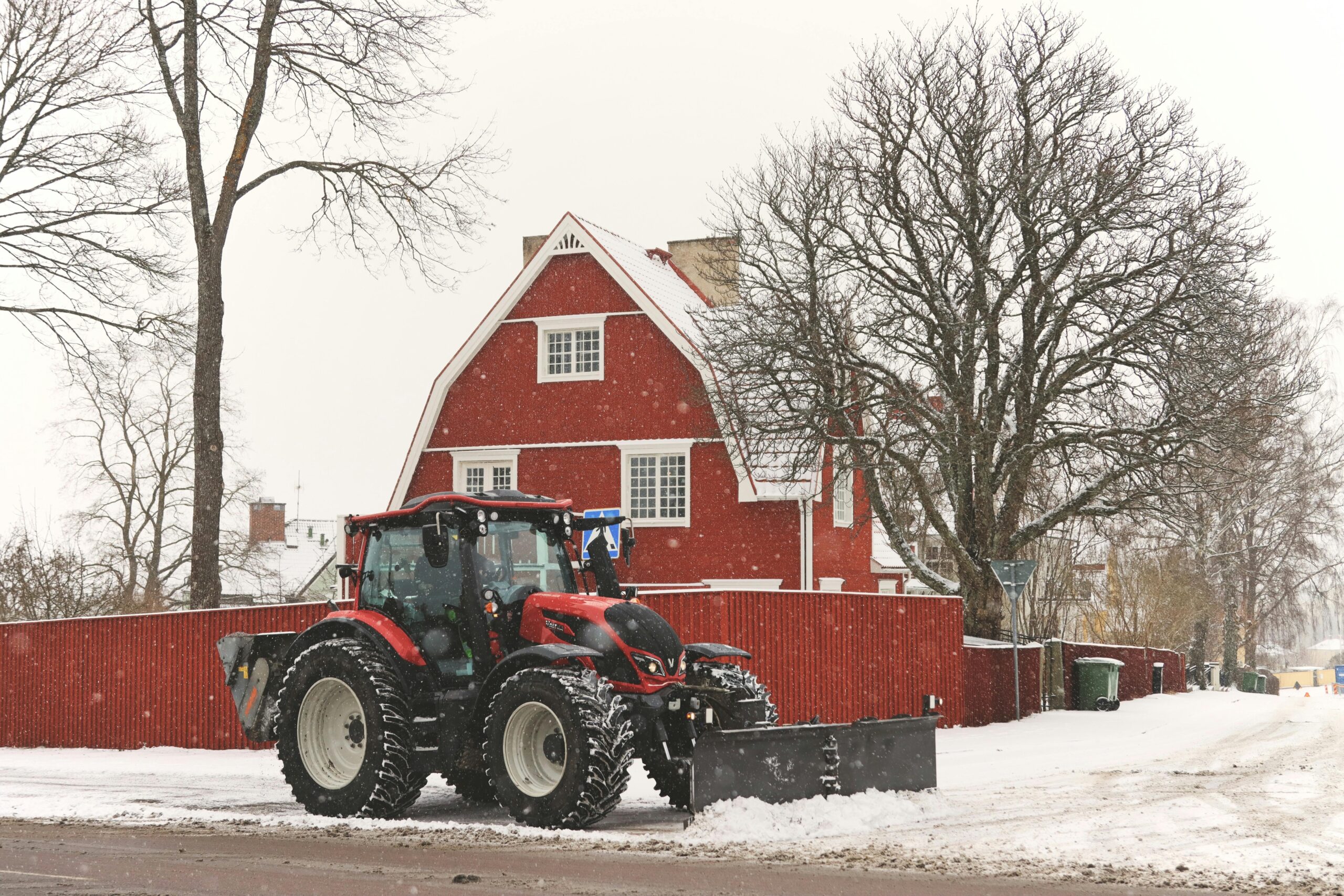 An image of Big Al's snow removal equipment working on a snow removal project in a residential area.