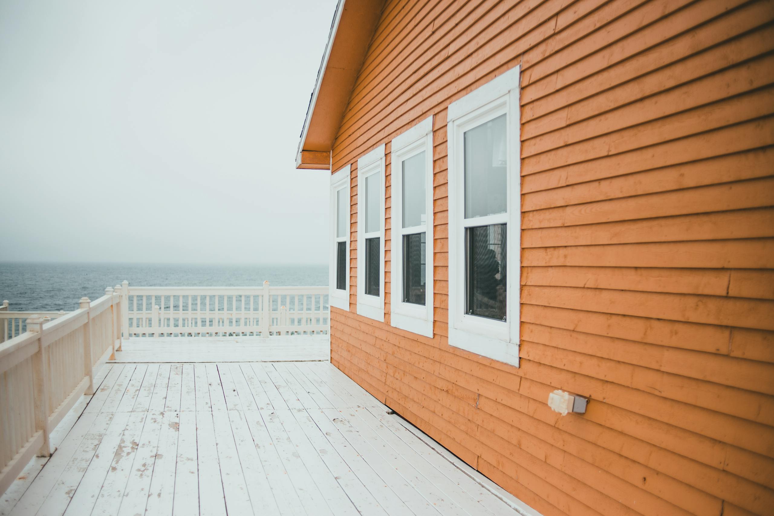 Charming wooden house by the sea with ocean view and bright deck.